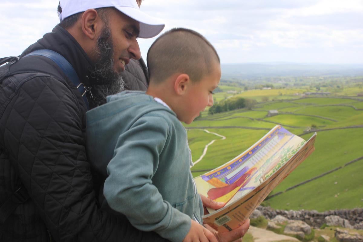 Mohammed Bashir reading to his son, Mohammed, aged 5. Their favourite books are anything about exploring and space!