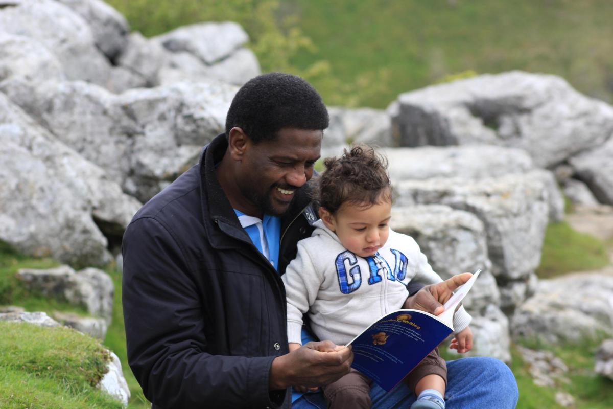 Sabir Hussain reading to his son, Taha, aged one. Their favourite book is Dogger by Shirley Hughes.