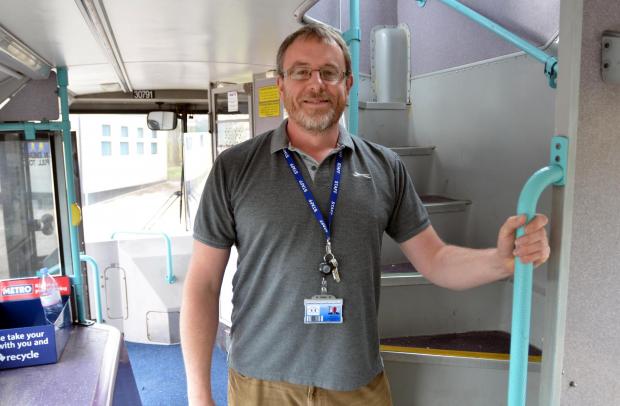 Bradford Telegraph and Argus: Ewan Clark, Farfield Primary School's business manager, inside the school's new library, which is a former First Bus