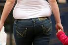 An overweight woman as predictions that half the British population will be obese by 2050 “underestimate” the scale of the obesity crisis, a report suggests