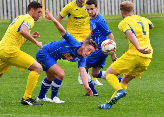 Callum Terrell is surrounded by Hemsworth Miners' Welfare players last Saturday as they made it seven straight league wins Picture: David Harrison