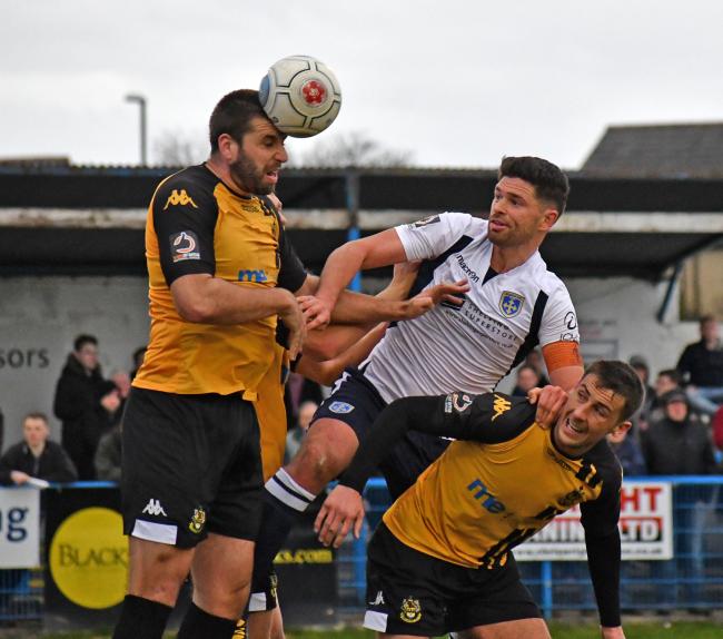 Guiseley's Scott Garner, centre, in he thick of the action against Southport. Picture: Richard Leach