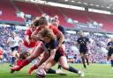 Ellie Kildunne squeezes in to score during England's 46-10 win over Wales in round two of this year's Guinness Women's Six Nations.